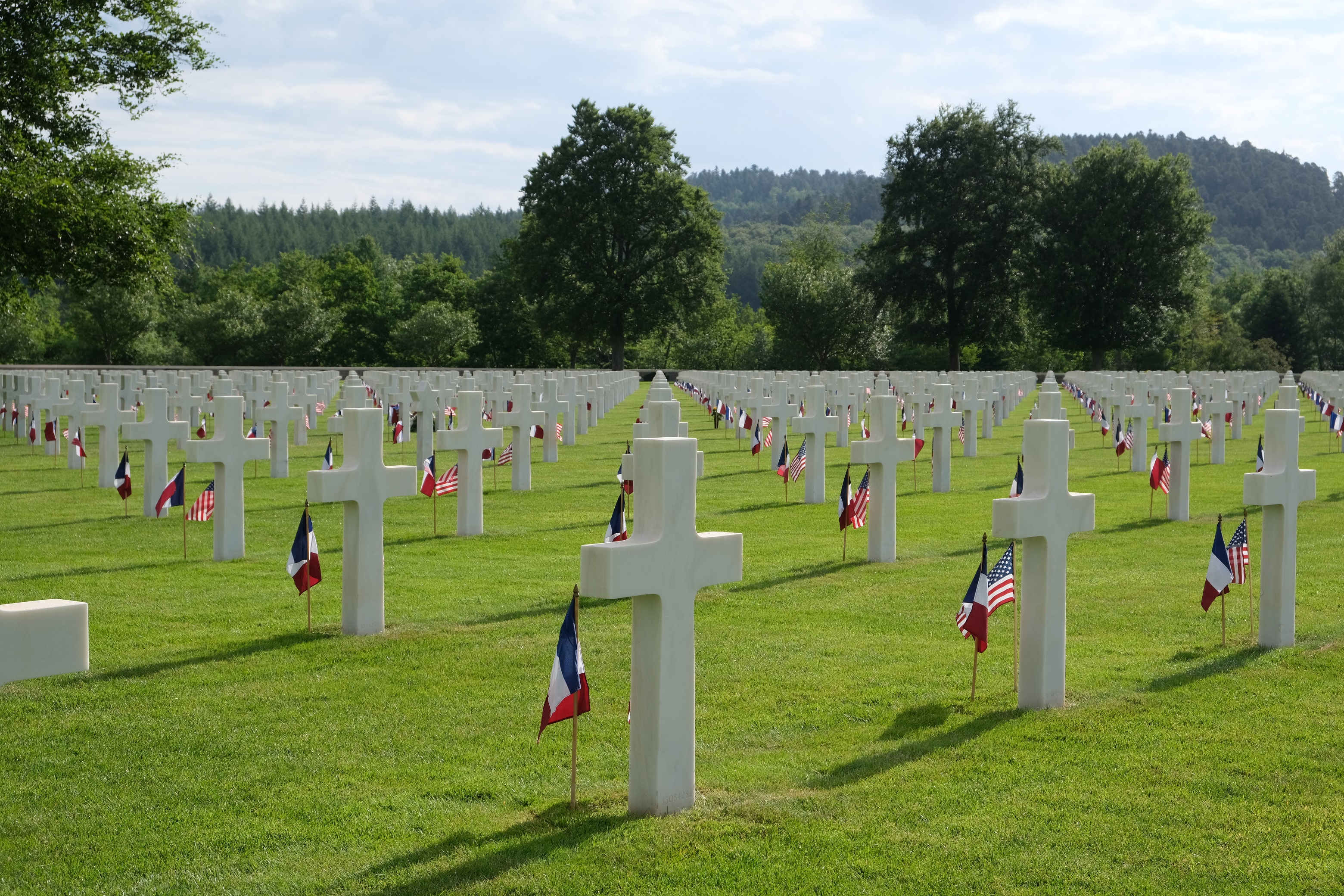 Graves are decorated with flags at Epinal American Cemetery for Memorial Day