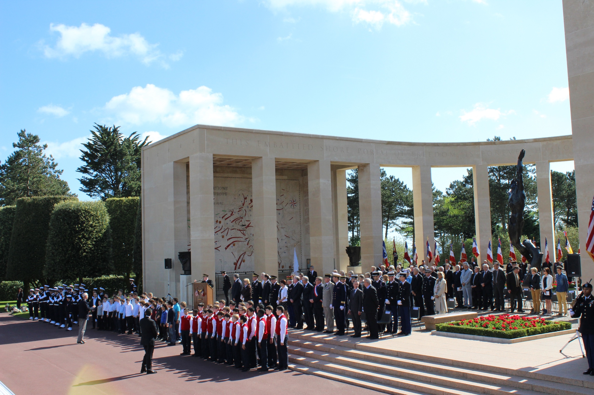 The choir and official party stand in the memorial area. 