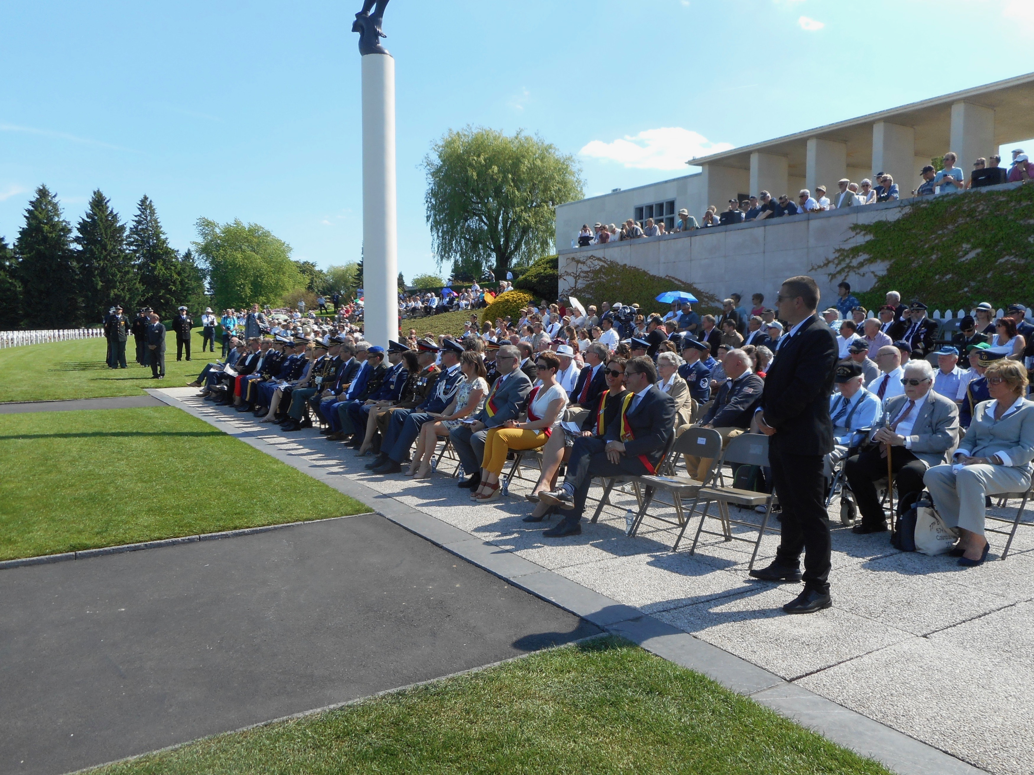 Attendees sit in chairs during the ceremony.