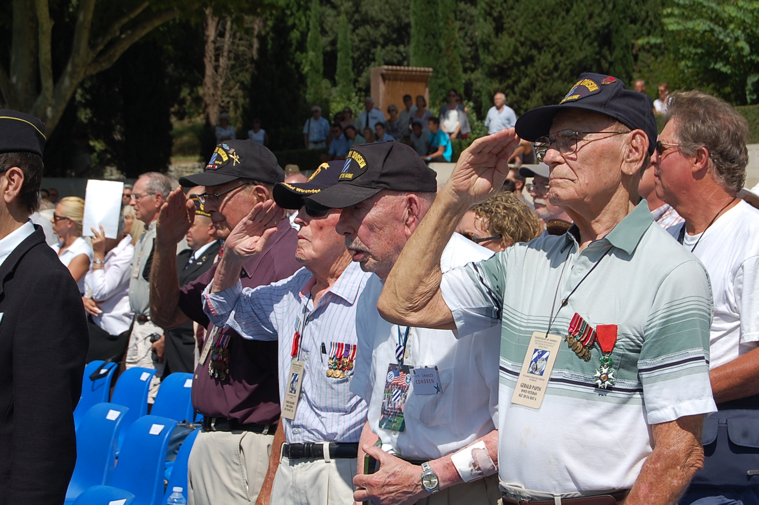 WWII veterans salute during the ceremony. 