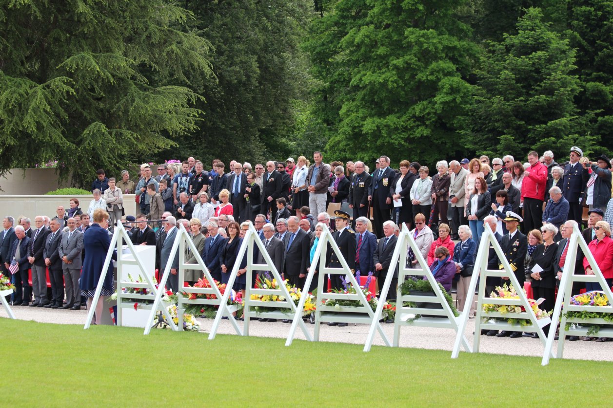 Members of the crowd stand during the ceremony. 