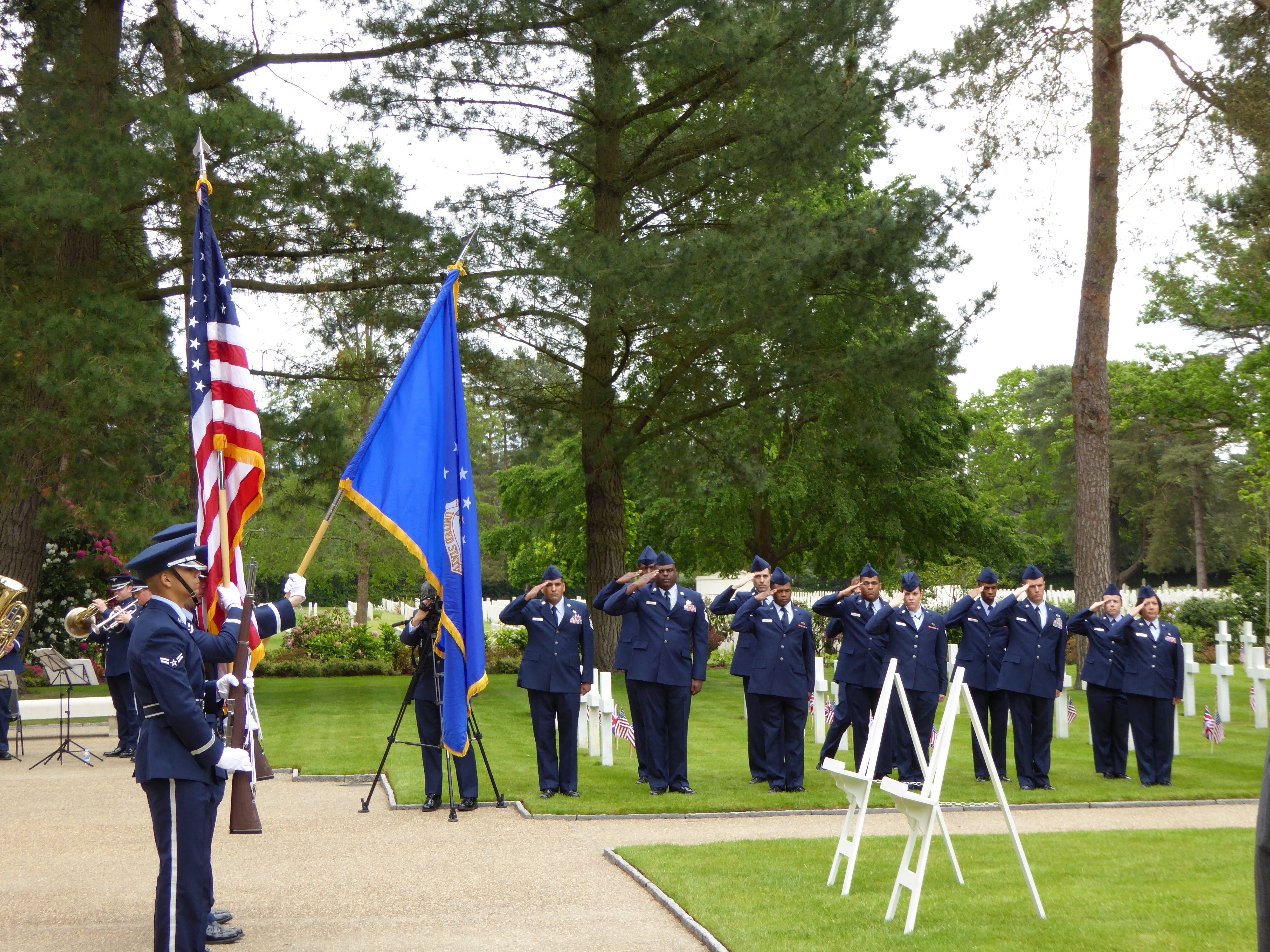 Airmen salute while the Color Guard posts the colors.