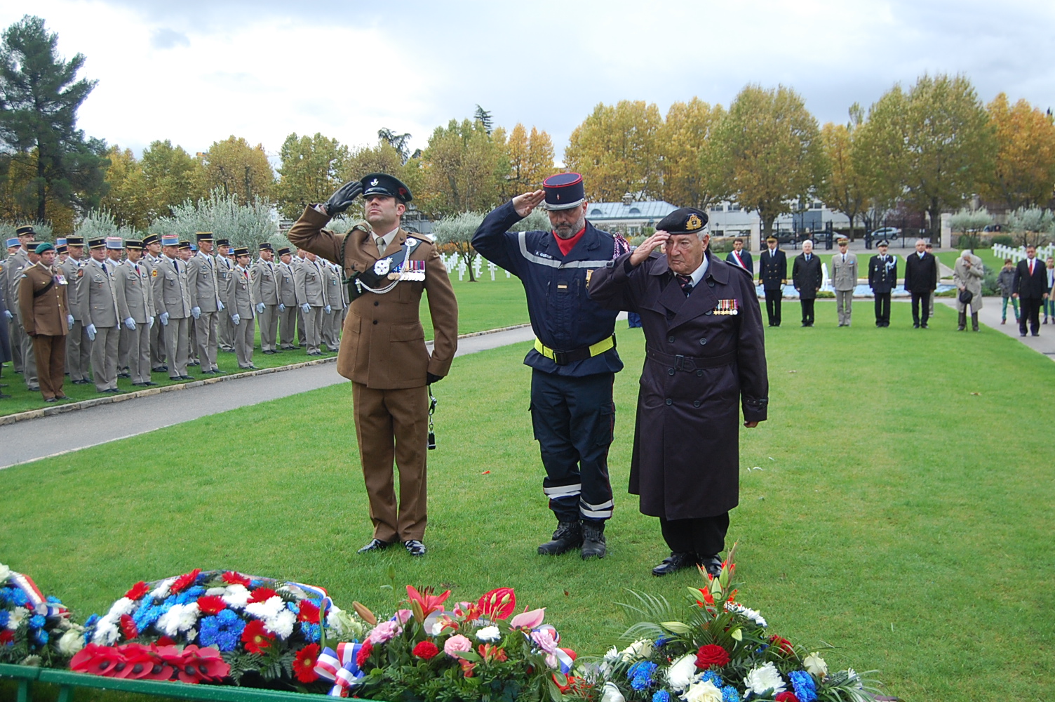 Ceremony participants salute wreaths after they are laid. 