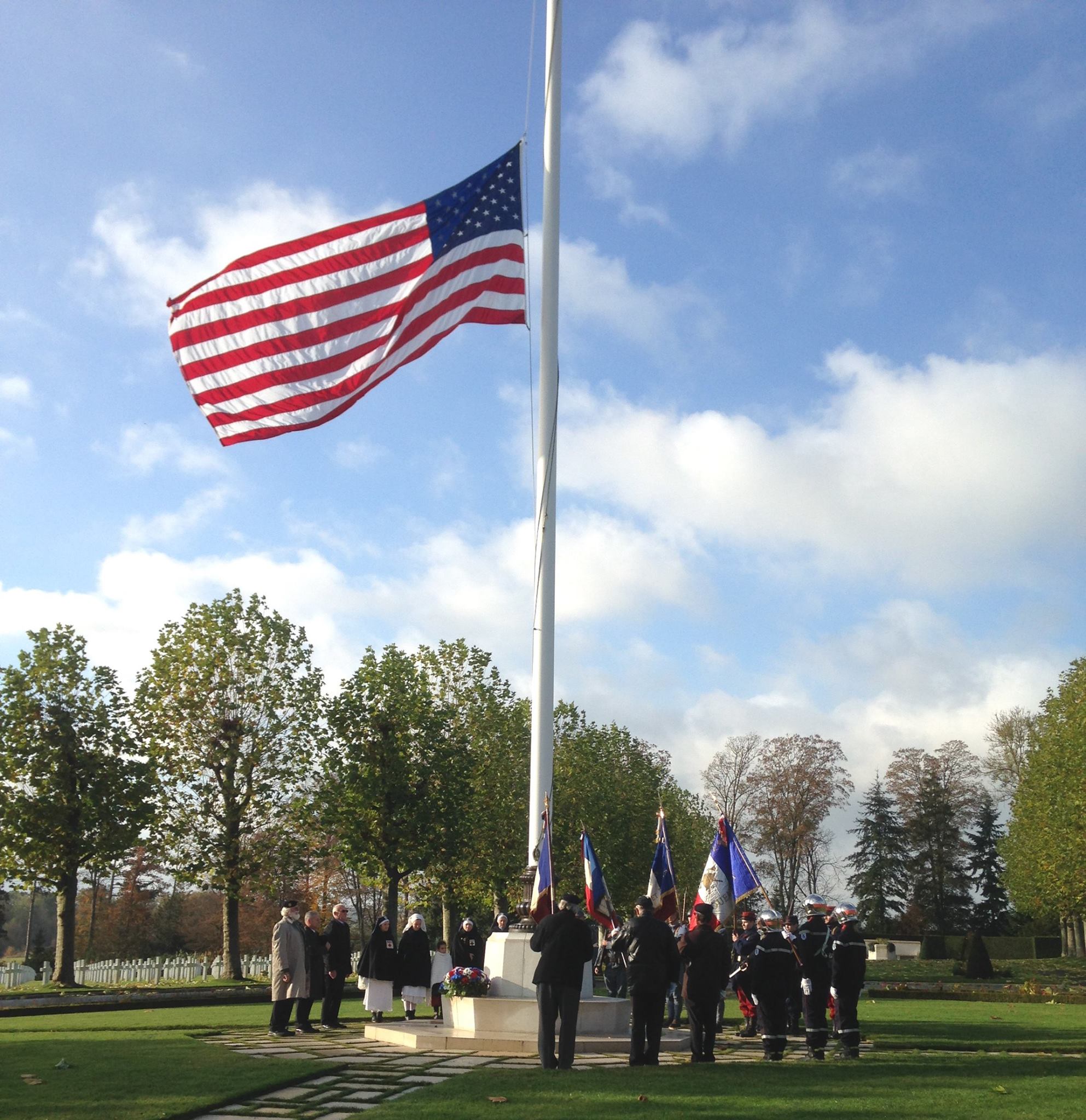 Attendees gathered around the flag pole during the ceremony. 