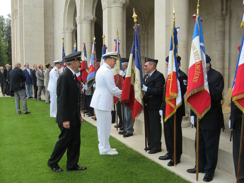 Rear Admiral Christenson shakes hands with flag bearers.