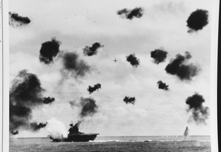Historic photos shows smoke coming from ship and heavy antiaircraft fire.