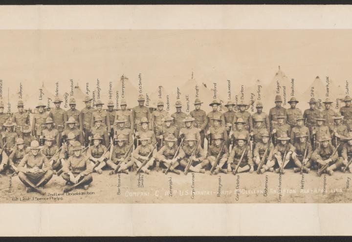 Historic photo shows unit photo of men in uniform from the 115th U.S. Infantry.