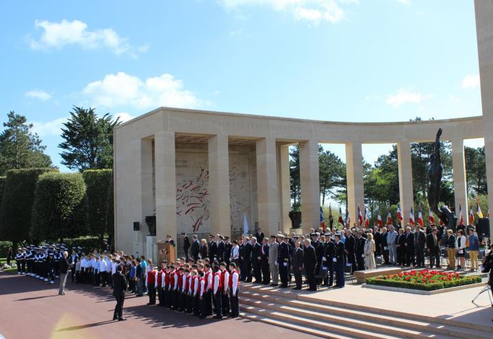 The choir and official party stand in the memorial area. 