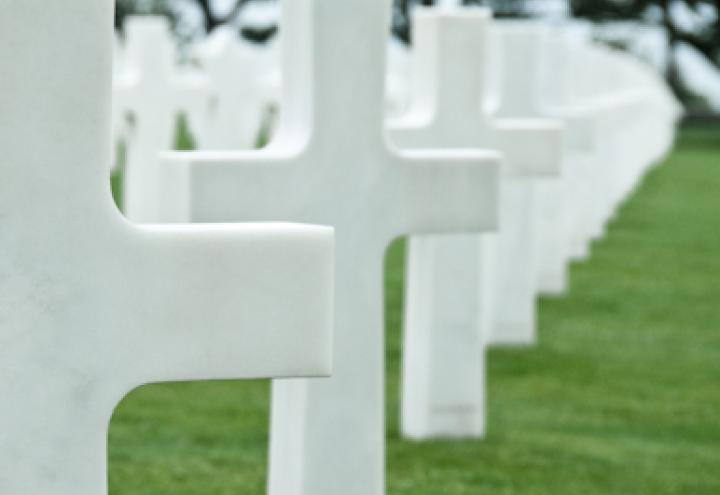 White headstones in a row at Normandy American Cemetery.
