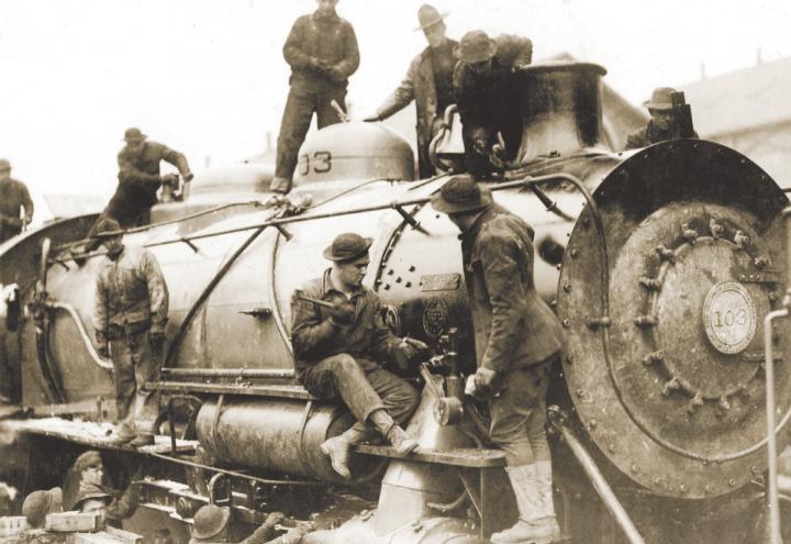 Services of Supply (SOS) soldiers build a locomotive at the assembly plant in St. Nazaire.