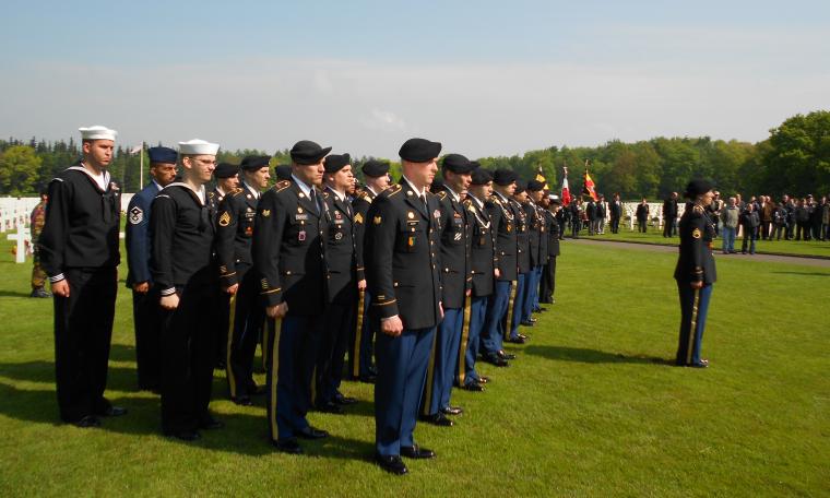 Members of U.S. military stand at attention. 