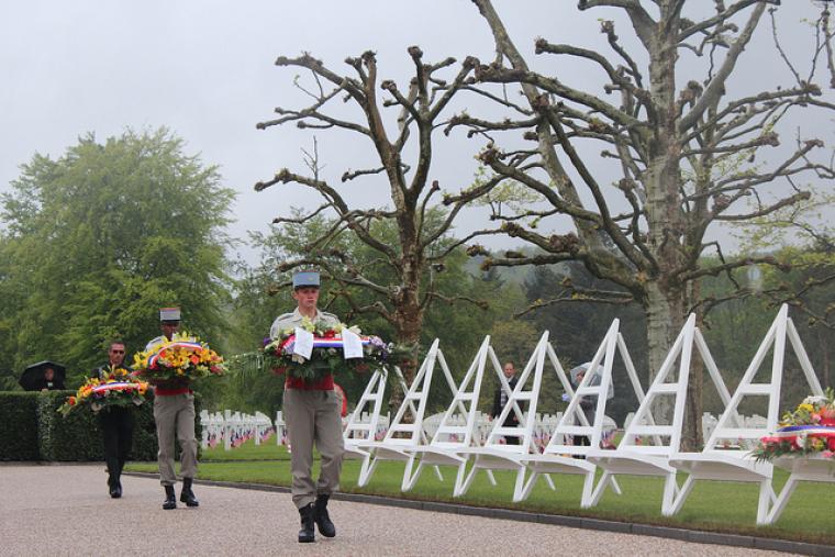 Ceremony participants walk with wreaths.