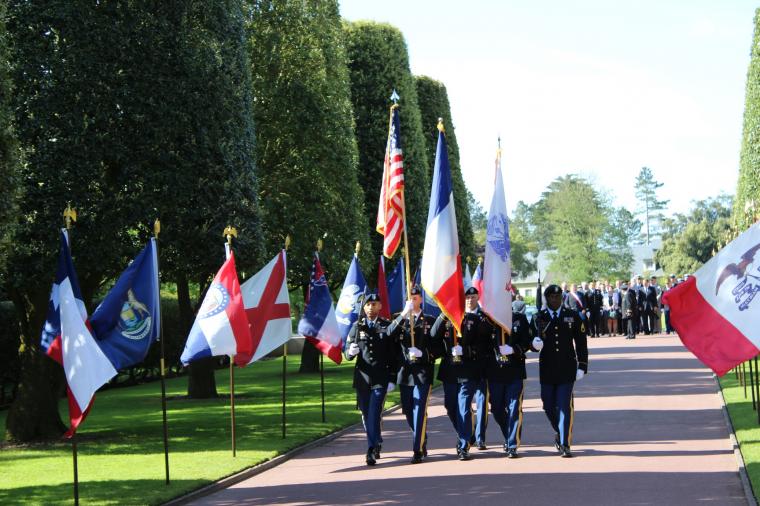 A color guard marches in with flags. 