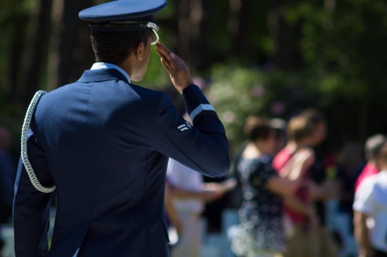 A man in uniform salutes during the 2012 Memorial Day ceremony at Brookwood American Cemetery.