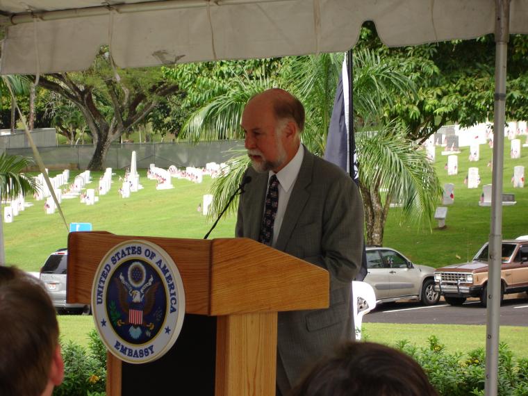 American Ambassador to Panama stands behind a podium and delivers remarks during the 2012 Veterans Day ceremony.