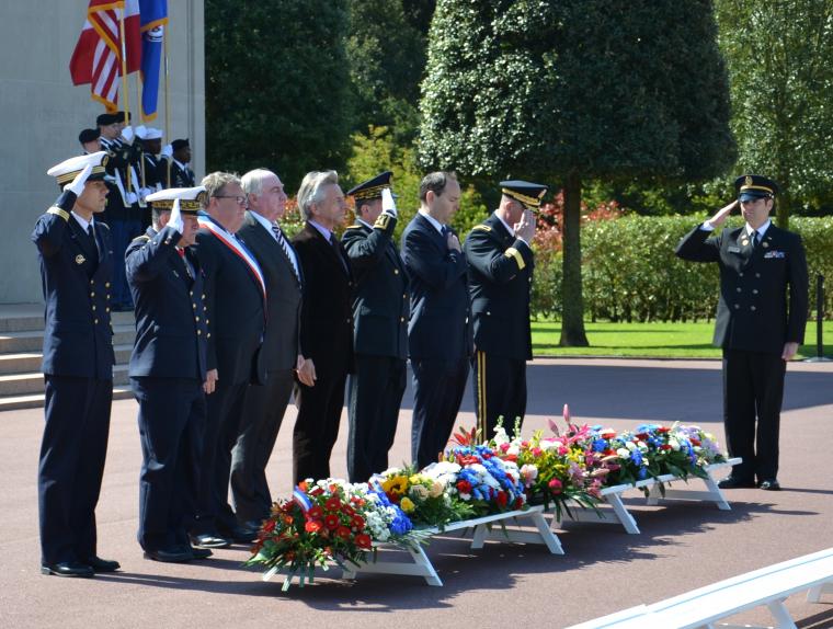 Official party lays wreaths, and members of the military salute after wreath-laying. 