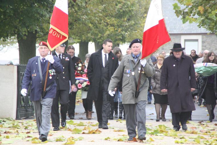 Participants arrive, two carrying flags, at the 2012 Veterans Day ceremony at Somme American Cemetery. 