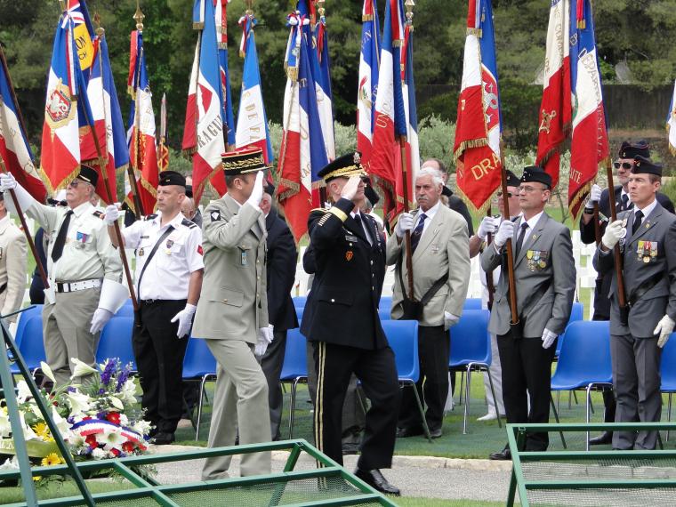 Members of the military salute while marching. 
