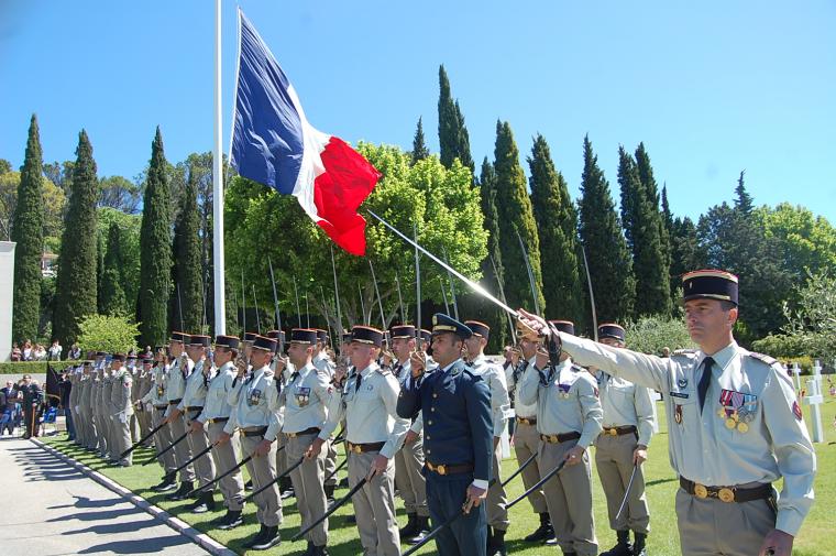 Members of the French military stand with sabers during the ceremony. 