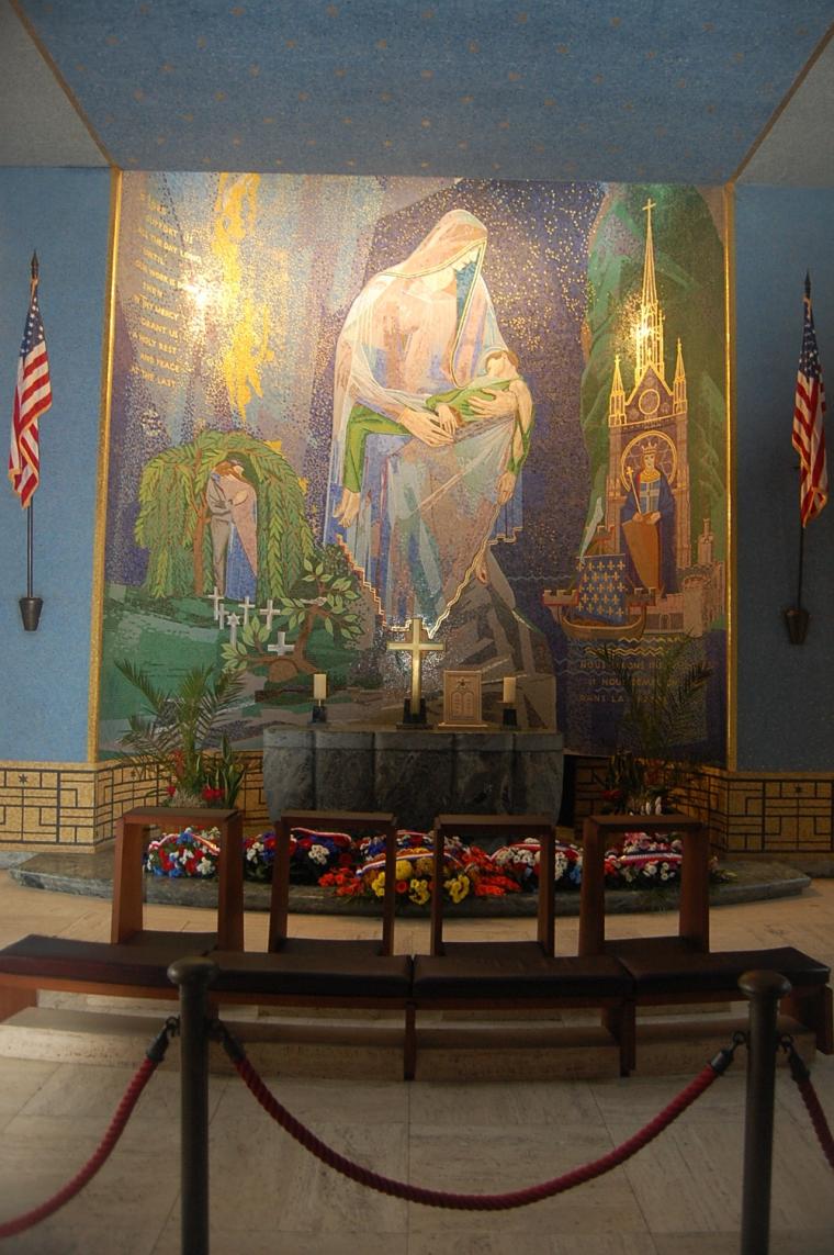 Wreaths lie in front of a mosaic wall in the chapel at Rhone American Cemetery after the 2012 Veterans Day ceremony.