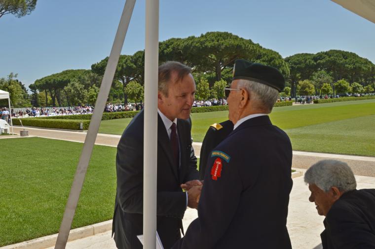 Ambassador Lane shakes hands with WWII vet Gutierrez. 
