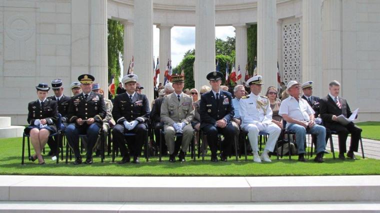 The official party, some in uniform, sit during the ceremony. 