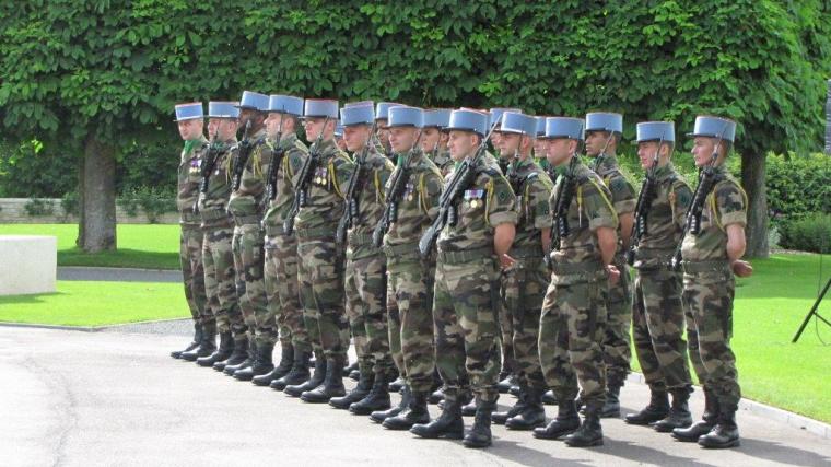 Members of the French military stand at attention. 