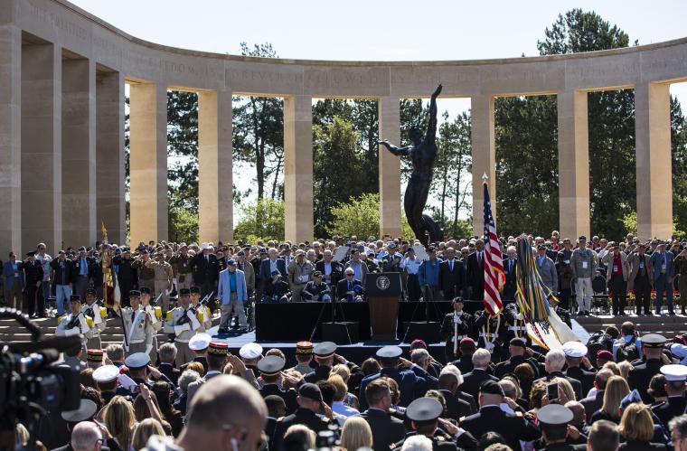  A large crowd sits during the ceremony with WWII veterans onstage.
