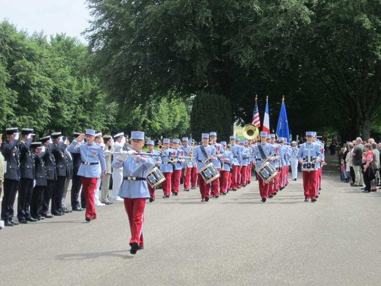 A French army band plays their instruments while they march. 