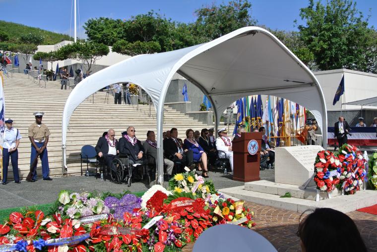 Participants sit under a tent at the Honolulu Memorial during the 2011 Veterans Day ceremony.