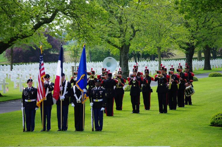 American honor guard stands with a French military band in background.