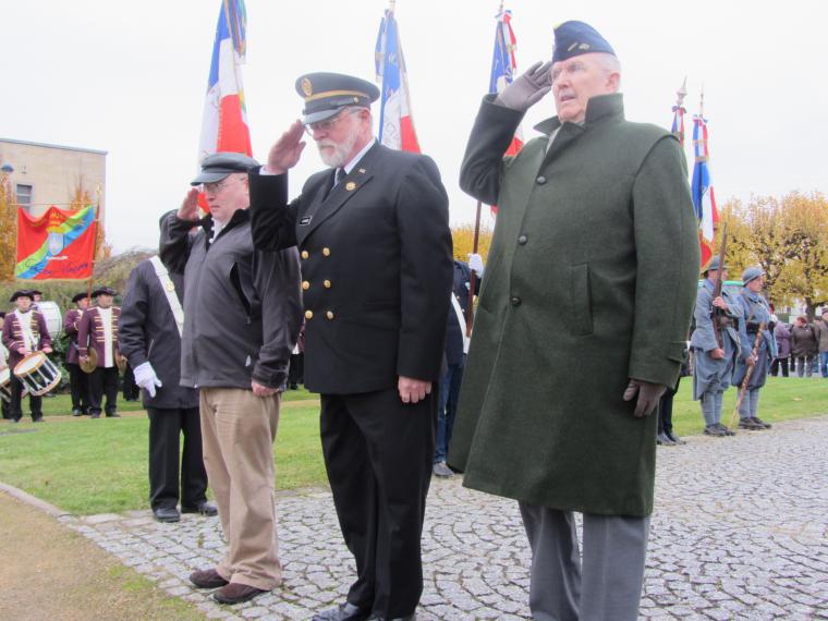 Three men stand saluting during a Veterans Day 2012 ceremony.