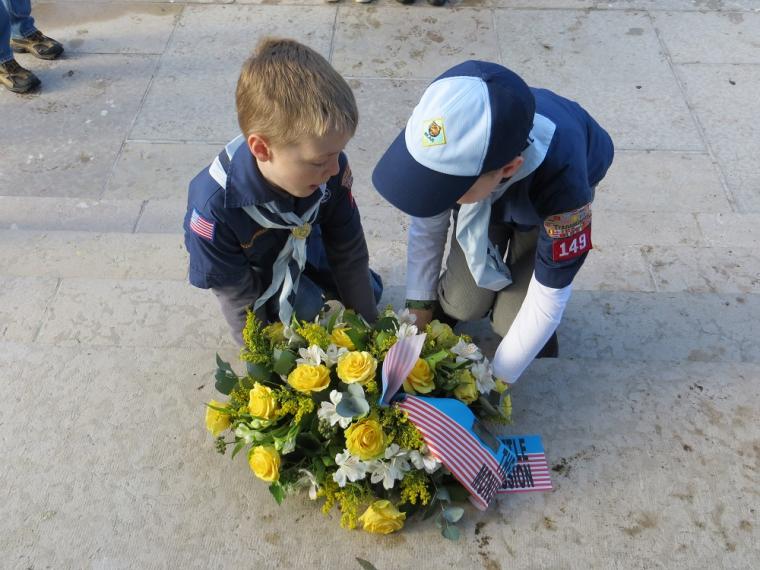 Two Boy Scouts kneel down and lay a wreath at Flanders Field American Cemetery as part of the 2012 Veterans Day ceremony. 