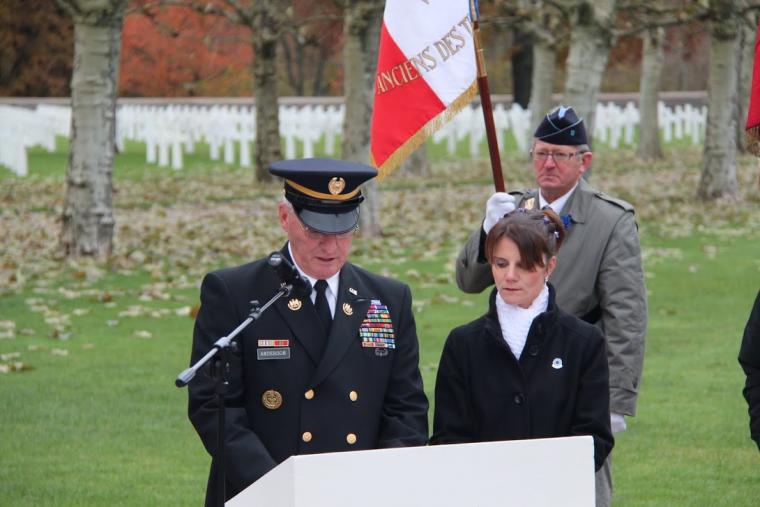 Epinal American Cemetery Superintendent Dwight Anderson stands behind a podium and delivers remarks during the 2012 Veterans Day ceremony. 