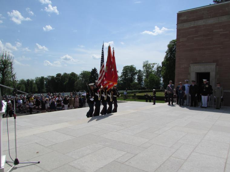 Marines carry flags or weapons as they serve in the honor guard.