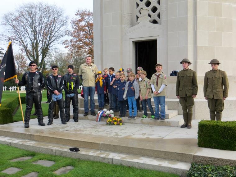 Motorcyclists, Boy Scouts, and World War I re-enactors stand in front of the chapel.