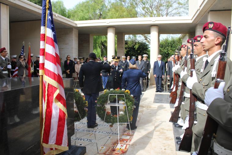 Members of the military salute after having laid wreaths at North Africa American Cemetery. 