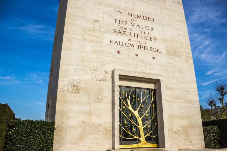 A gold-leafed tree adorns the doors of the chapel building at Netherlands American Cemetery 