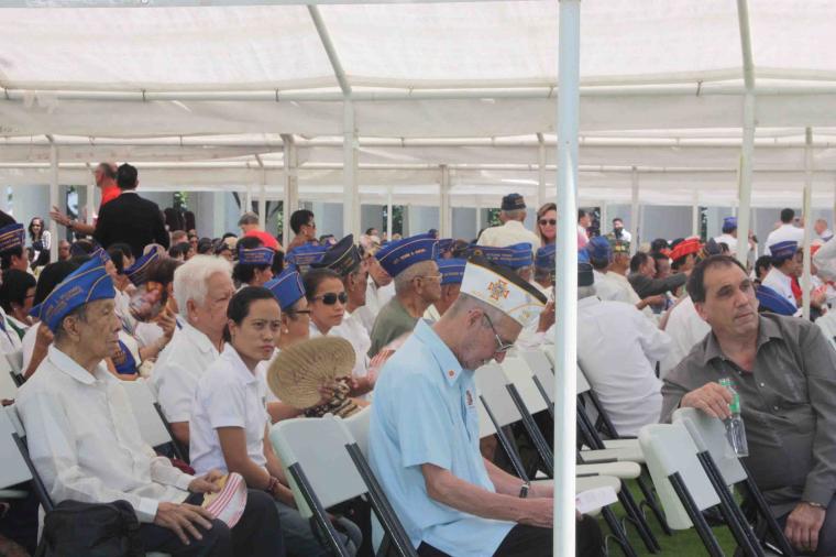 Attendees sit under a tent at Manila American Cemetery for the 2012 Veterans Day ceremony. 