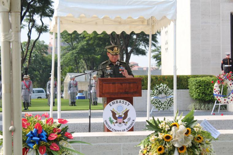 A Philippines military officials stands at the podium and delivers remarks. 