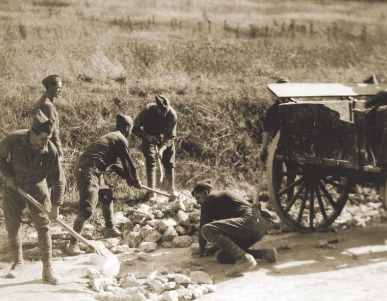 Engineer soldiers at Montsec repairing shell holes made by U.S. artillery, September 15, 1918.