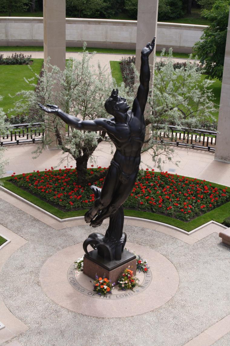 A bronze sculpture is at the center of the Normandy American Cemetery memorial area.