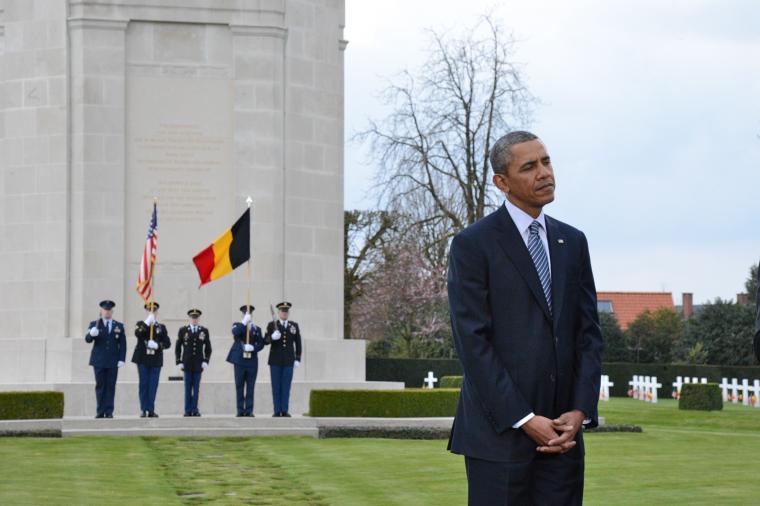 President Obama stands in the cemetery; Color Guard seen in background.  