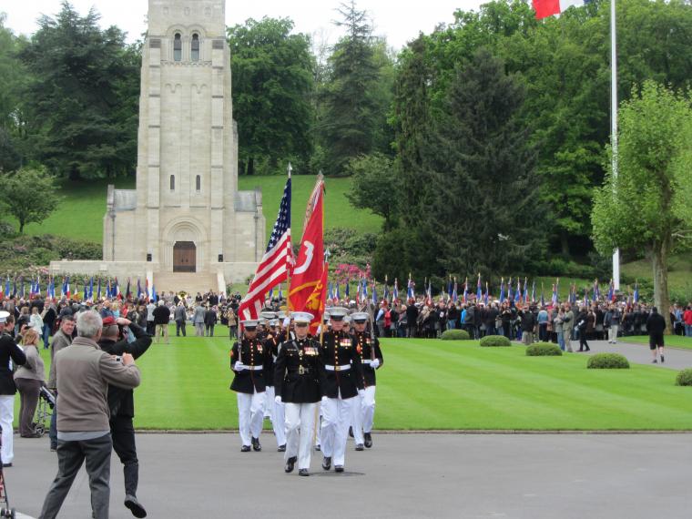 Marines march with flags during the ceremony.