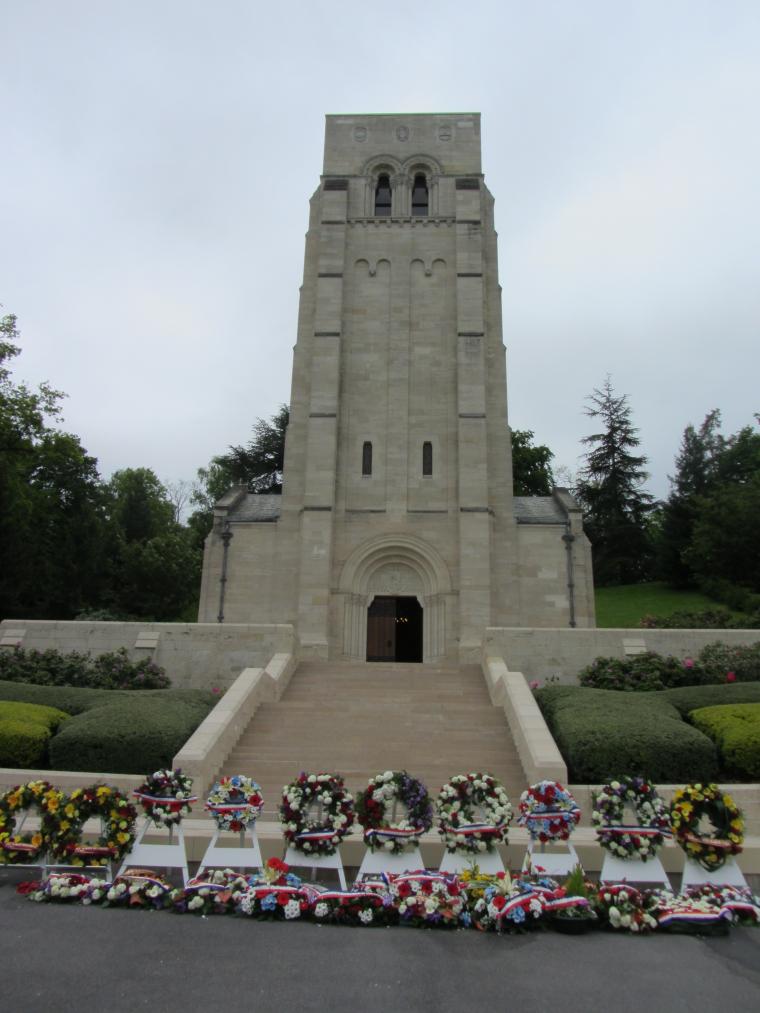 Floral wreaths sit at the foot of the chapel steps at Aisne-Marne.