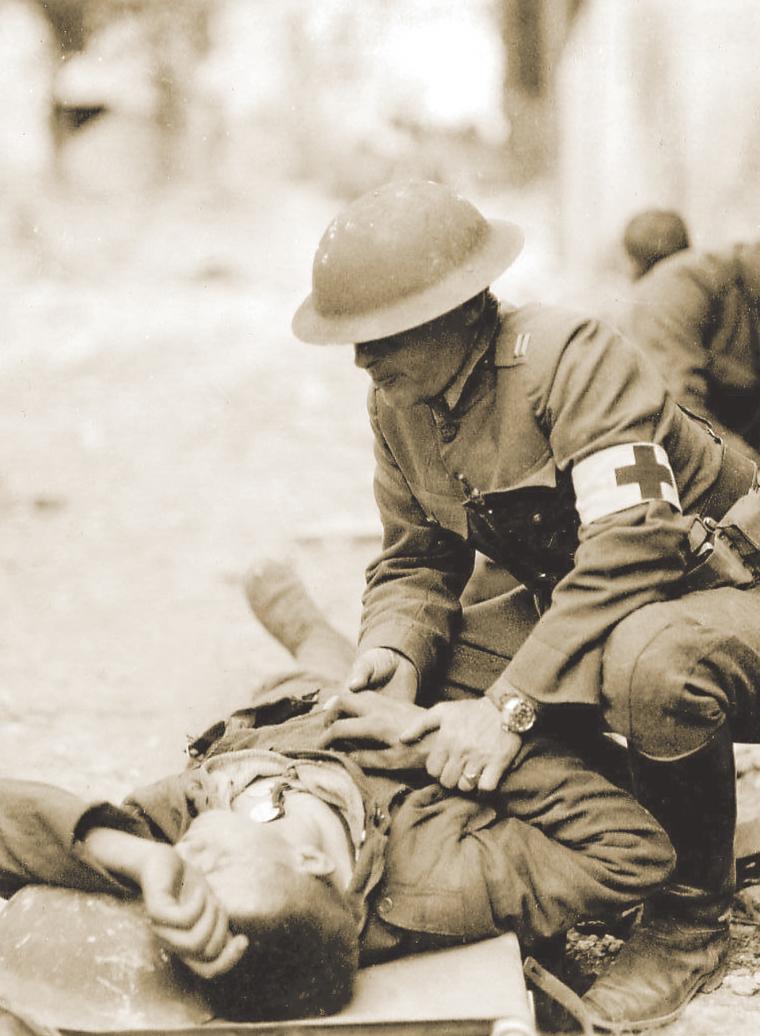 3rd Division surgeon examines an injured soldier, July 22, 1918.