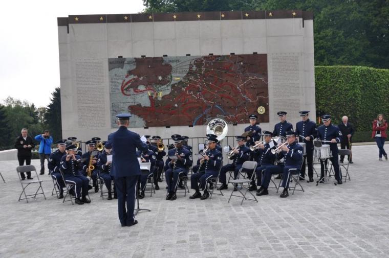 An Air Force band performs in front of a battle map.