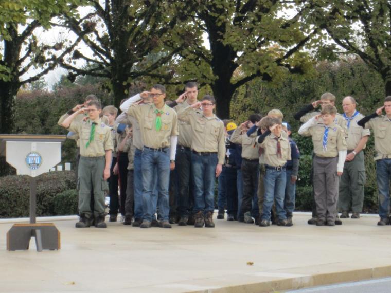 Boy Scouts salute during the 2012 Veterans Day ceremony at Meuse-Argonne American Cemetery. 