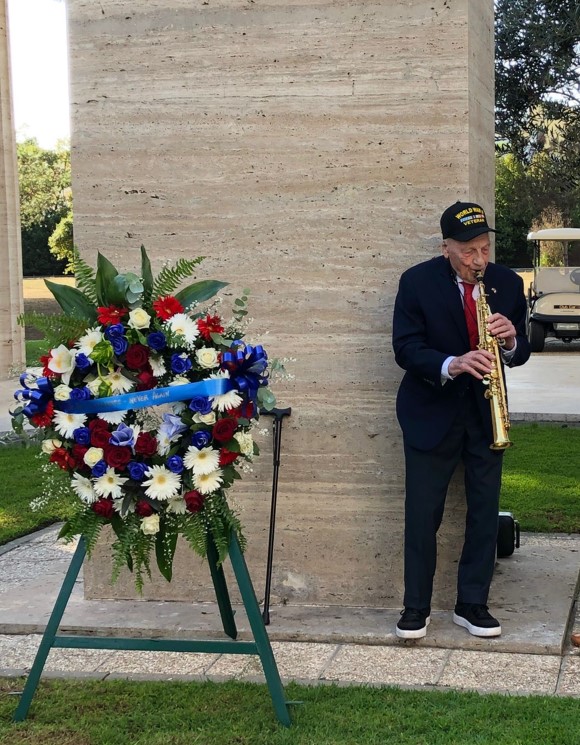 World War II veteran Dominick Critelli playing Taps for his comrades at Sicily-Rome American Cemetery. Credits: ABMC.