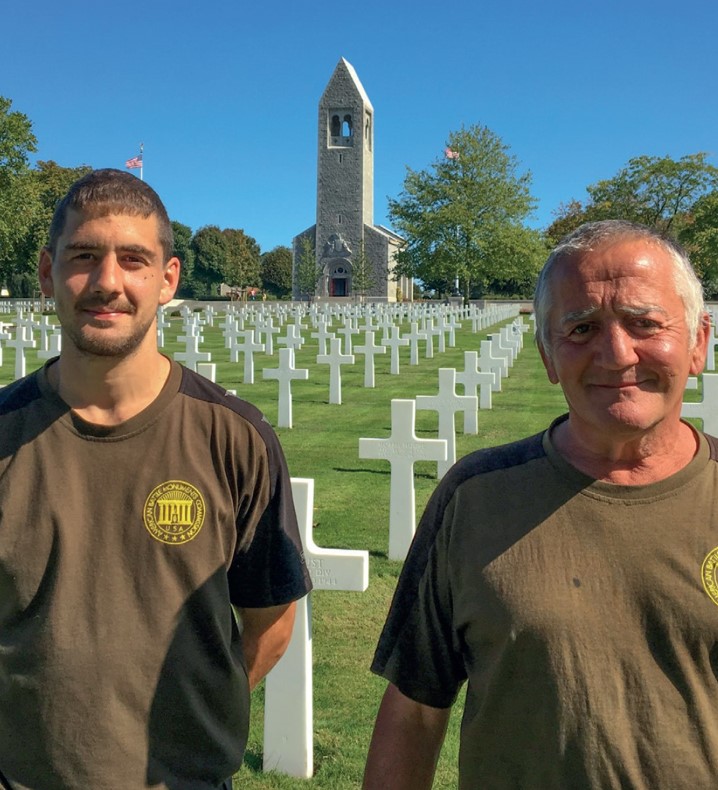 Alain Rocfort and his son Valentin in front of the chapel and headstones at Brittany American Cemetery. Credits: American Battle Monuments Commission